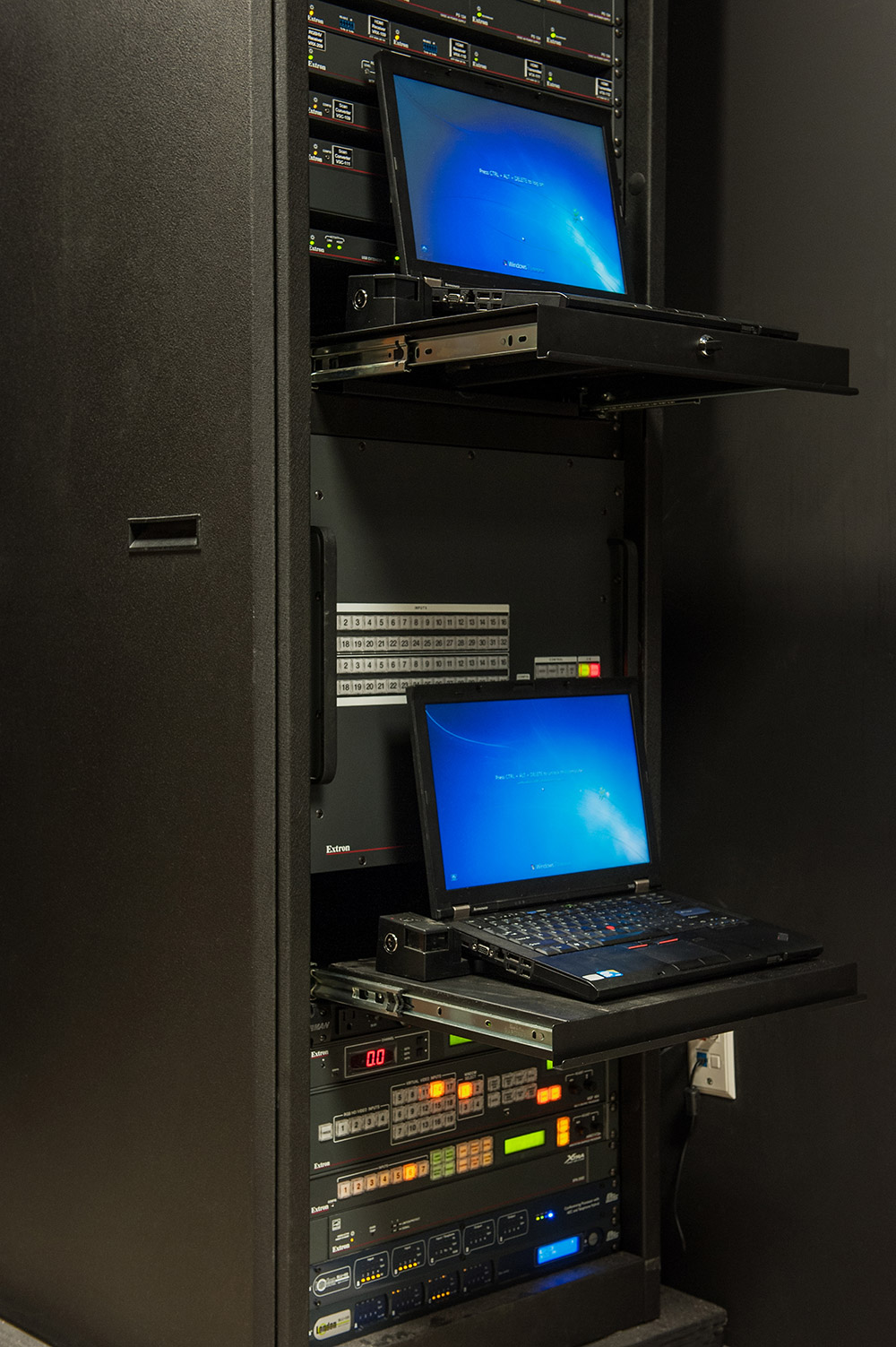 AV equipment for the Executive Conference Room is rack-mounted in a room located behind the embedded 103" plasma display.