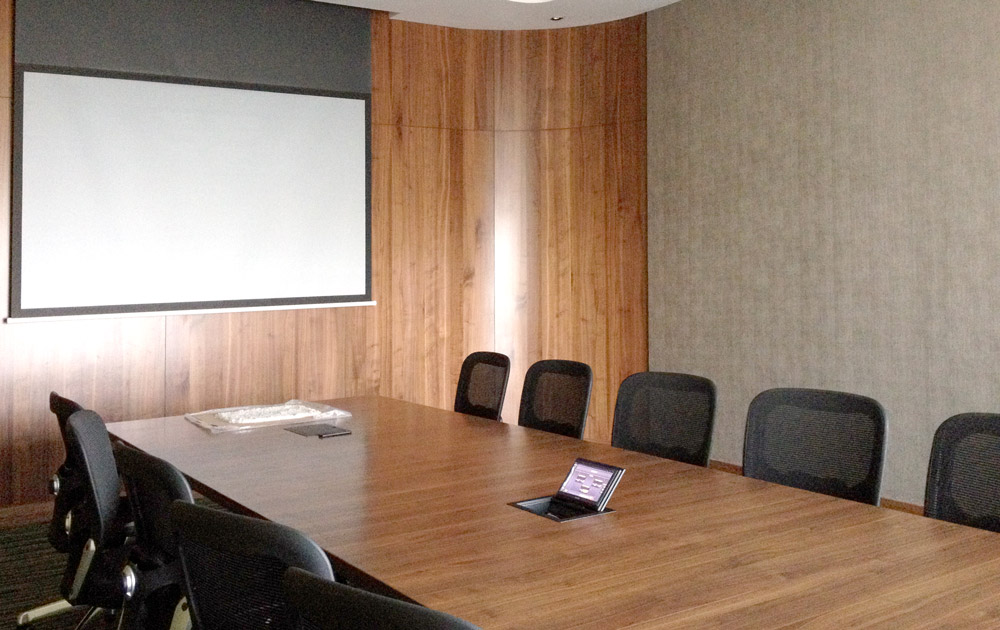 A single XTP CrossPoint 1600 provides AV and control signal switching and distribution within the four-way divisible boardroom and training space.