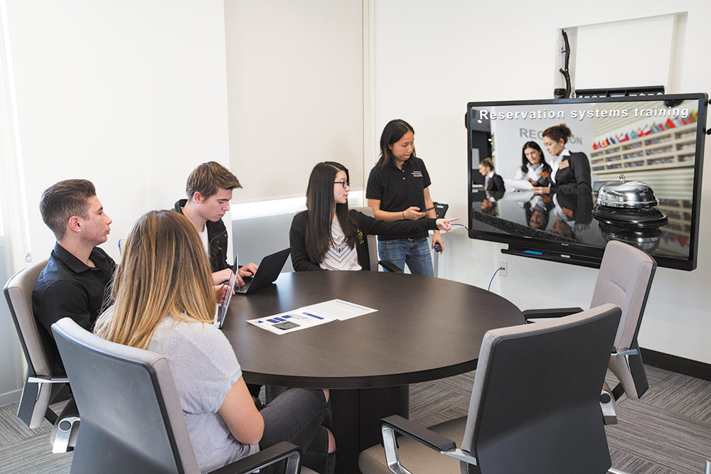 Group Study room with students looking at a flat panel display
