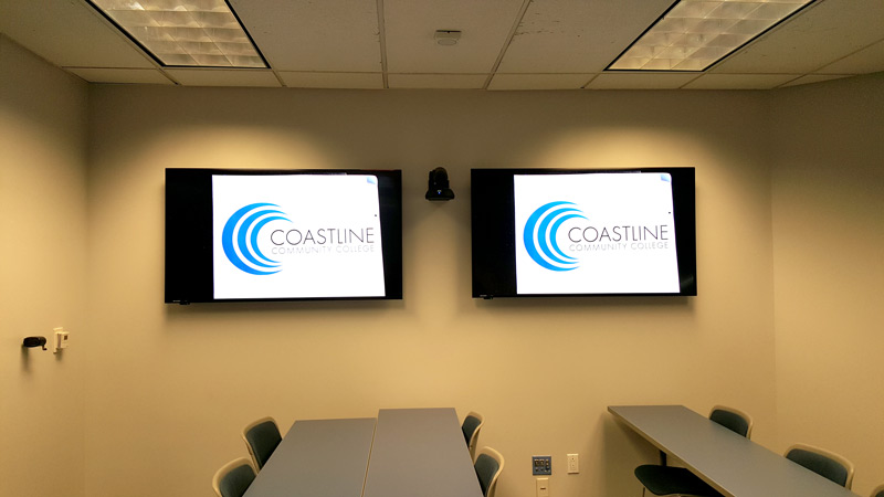 Room with two flat panel displays mounted on wall