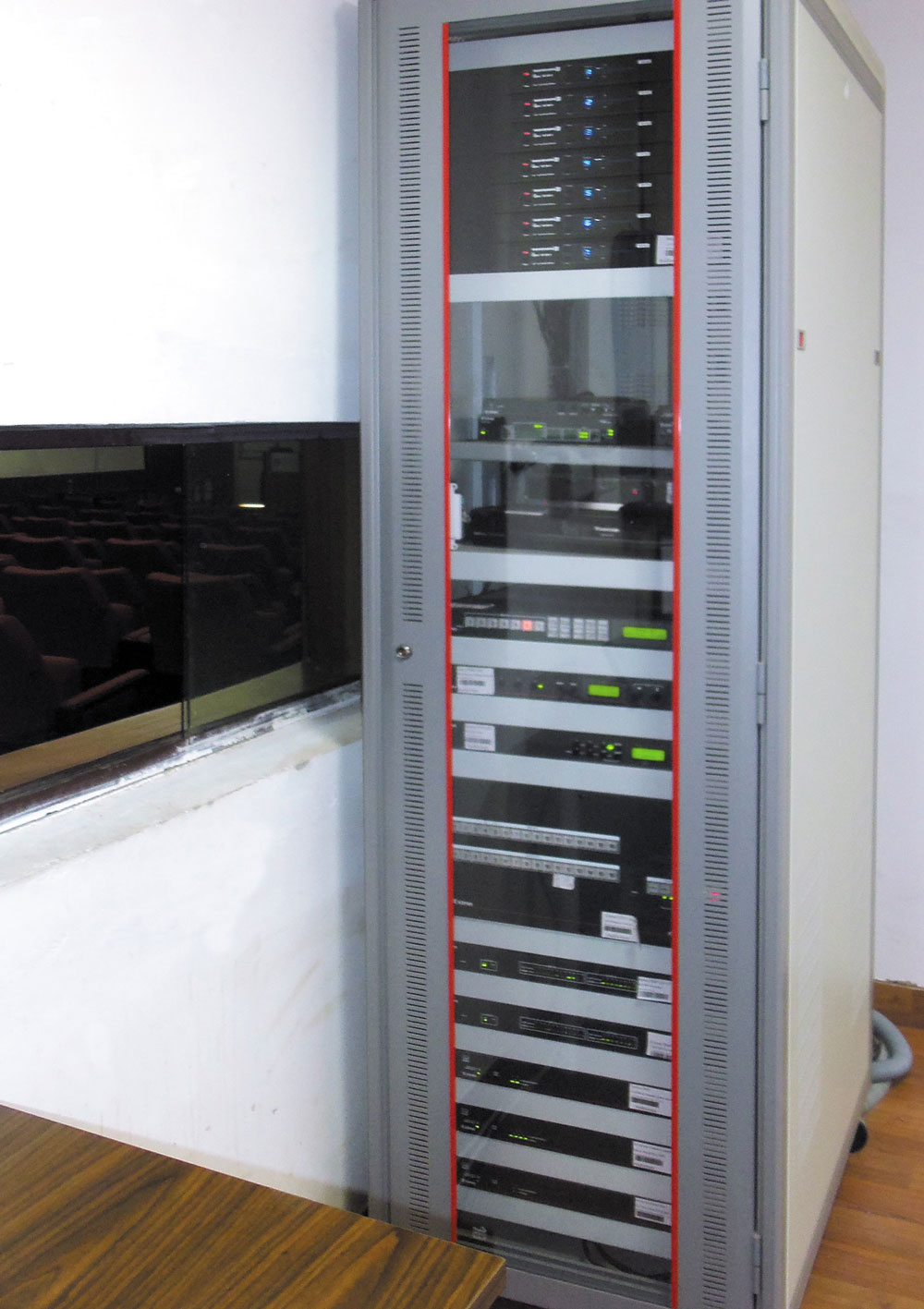 A single equipment rack in the control room houses most of the AV equipment for the auditorium, conference room, and training room.