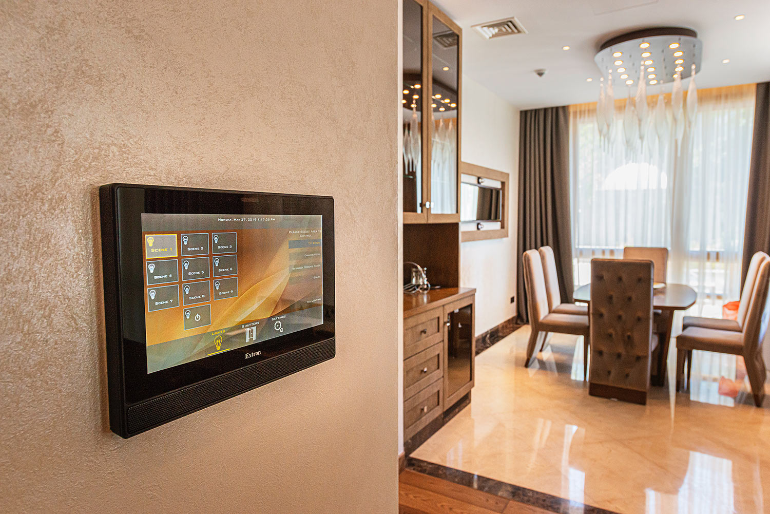 Wall-mounted touchpanel in a villa