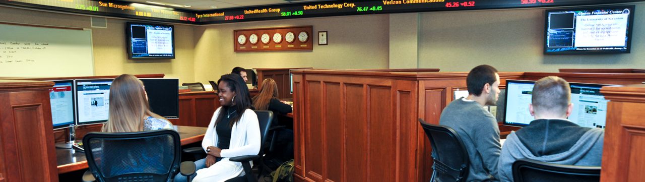 Student sitting in the Alperin Trading Room