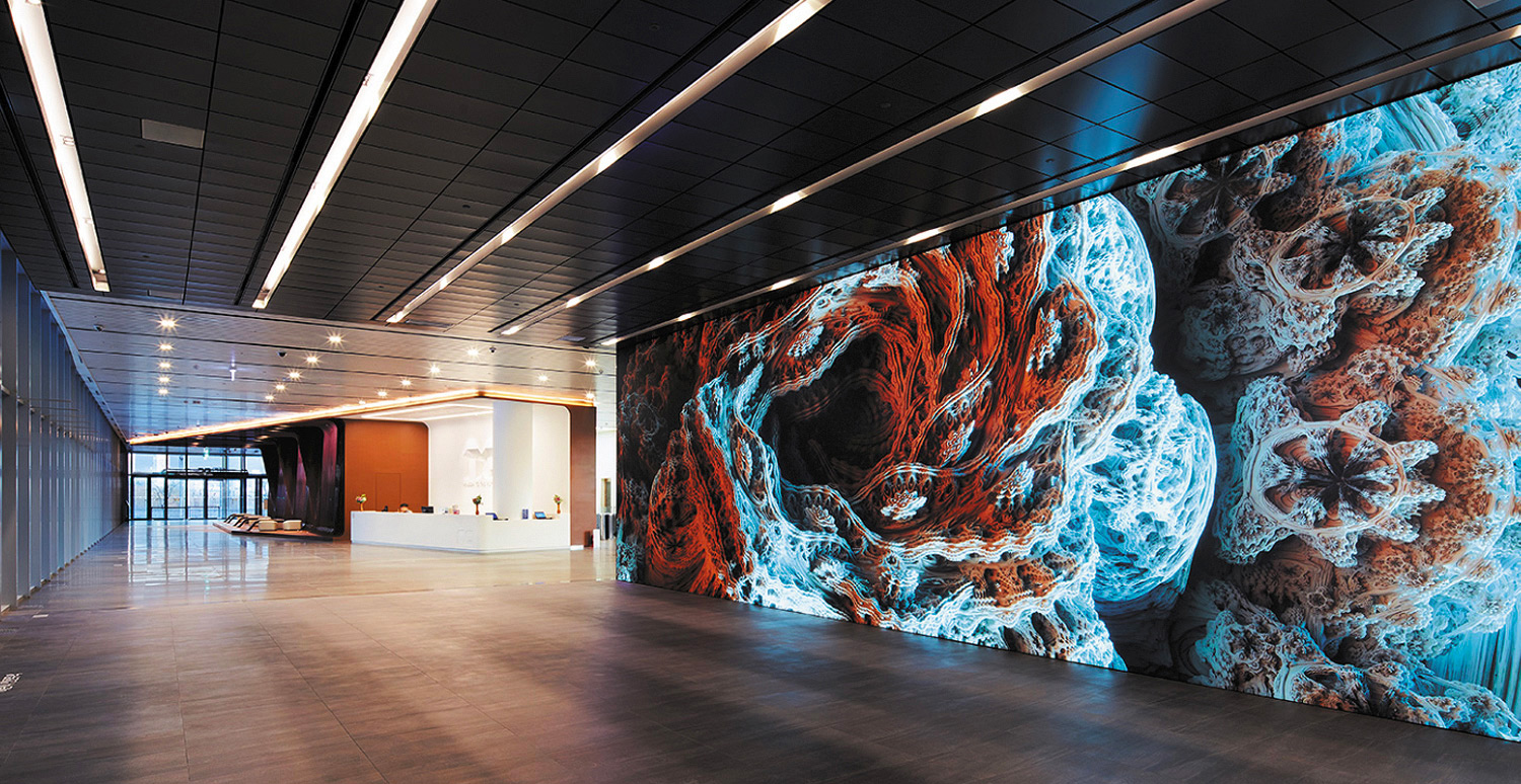 A lobby with a large projector screen running the length of the wall.