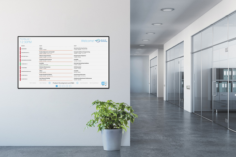 Extron Room Scheduling panel in an interactive list view placed on an office wall (landscape layout).