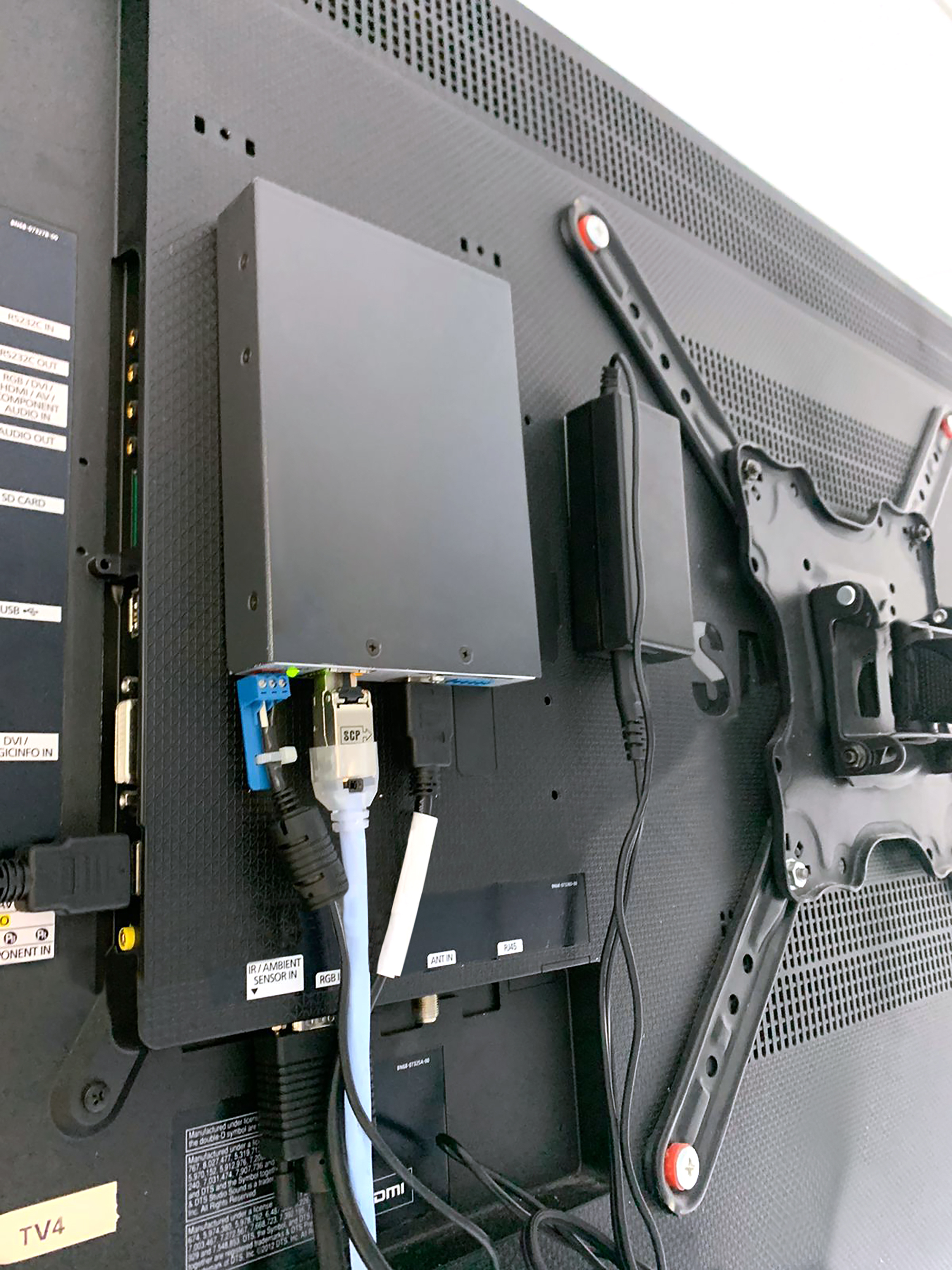 An Extron DTP 4K HDMI receiver is installed behind each display, receiving signals over twisted pair cable from the Quantum Ultra videowall processor in the equipment rack.