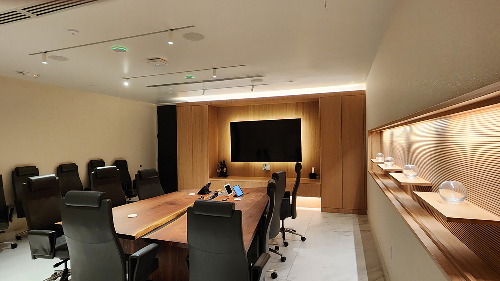 Executive conference room featuring integrated AV control, full-room audio, and a wall-mounted display powered by Extron DTP systems.