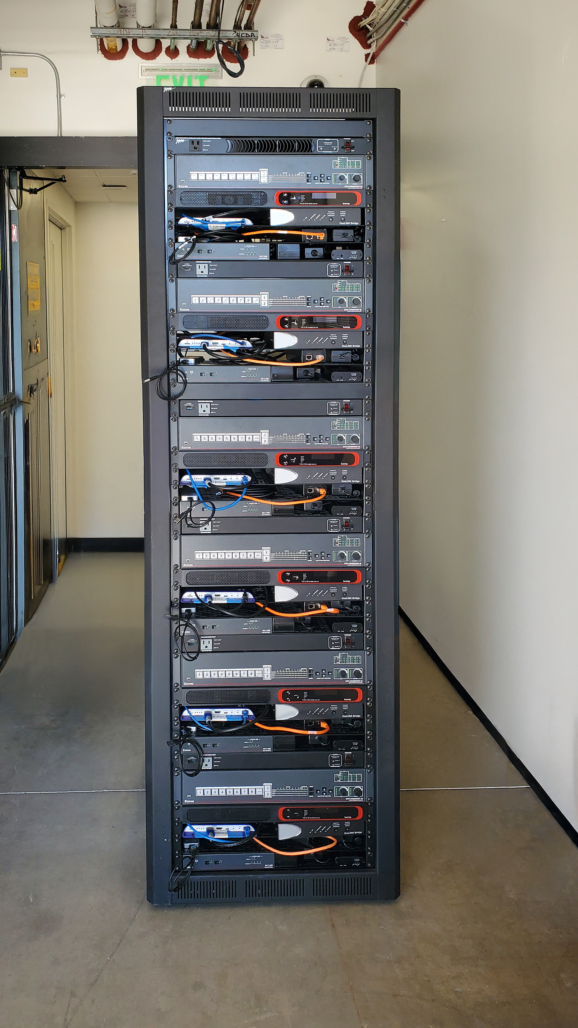 AV equipment rack housing multiple  Extron DTP2 CrossPoint switchers along with DSP, amplification, and control hardware.