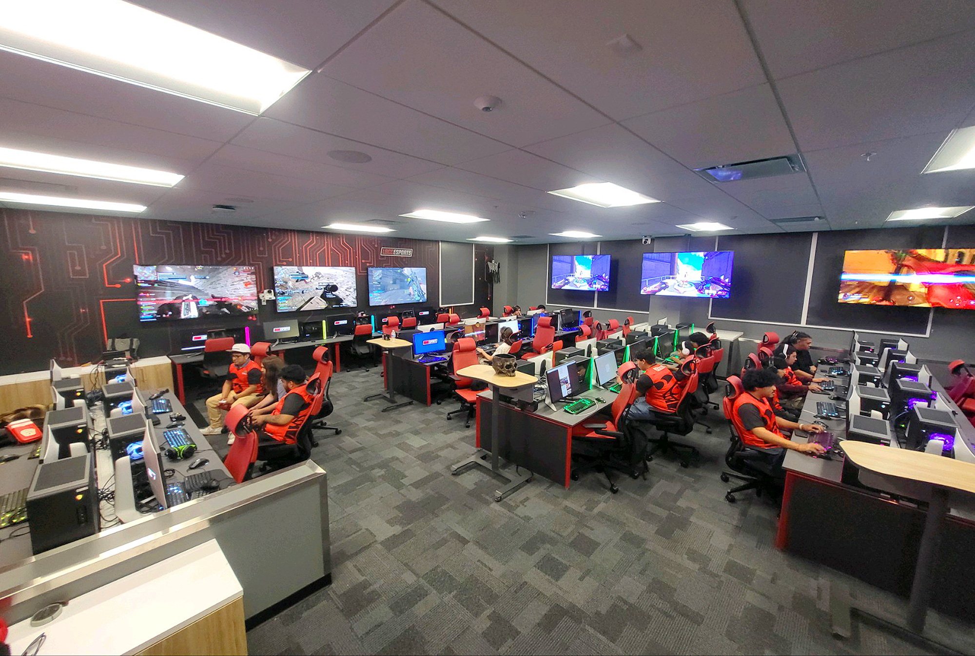 The gaming floor is surrounded by seven 75” displays. Five tracking PTZ cameras capture views of players in action.