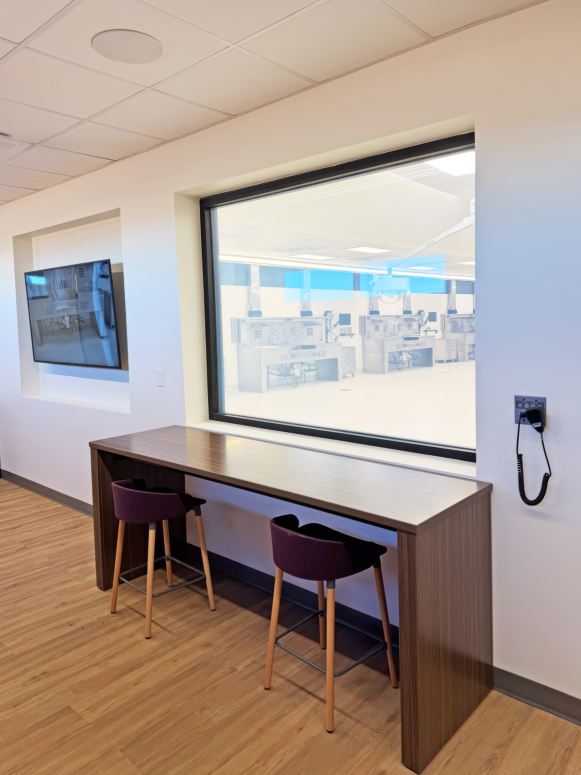 The observation area provides a quiet space for viewers. The window gives a clear line of sight into the autopsy room during live procedures.