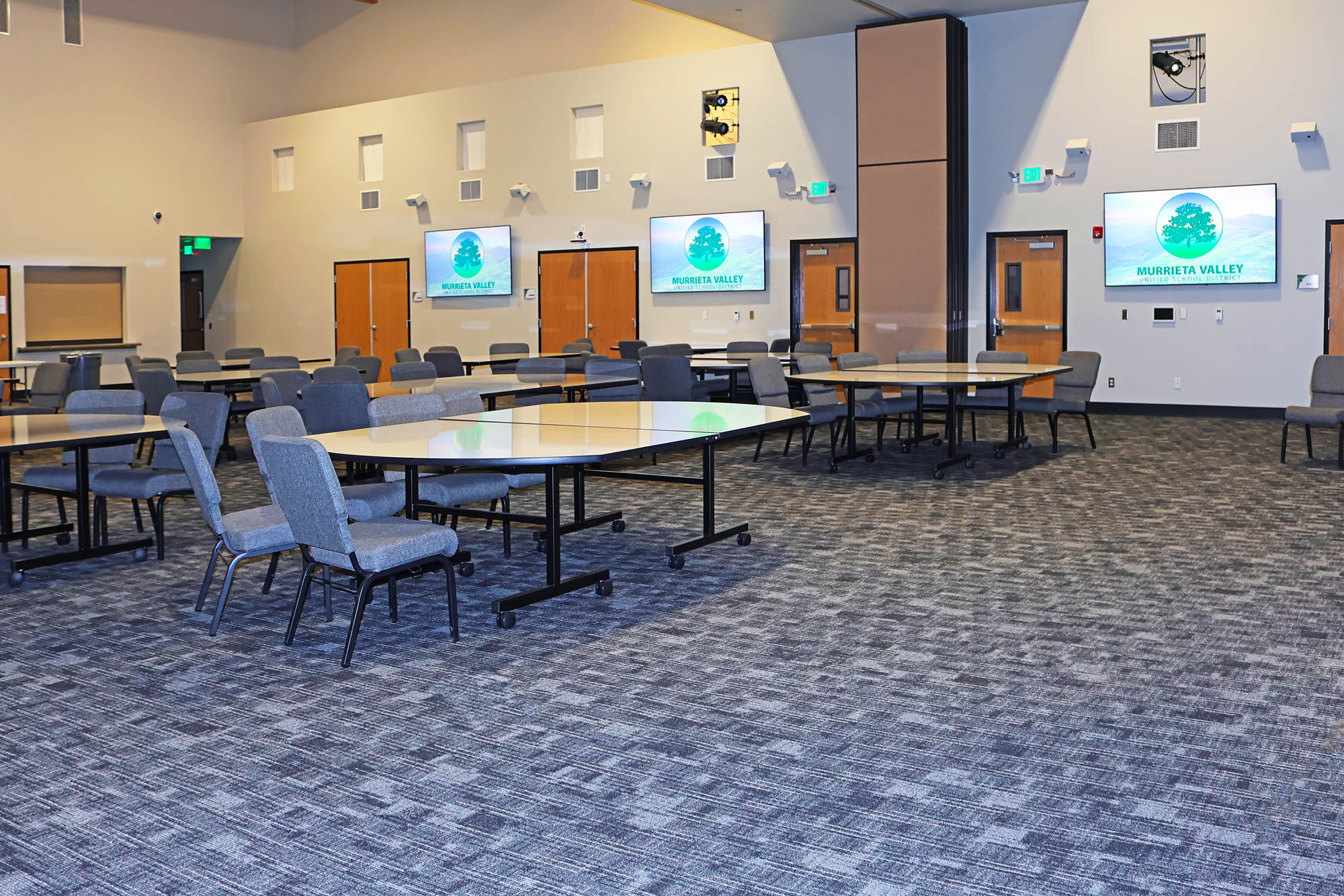 The Multipurpose Room has a foldable divider wall. Each half of the divided space has four flat panel displays, two on the north wall, and two on the south wall.