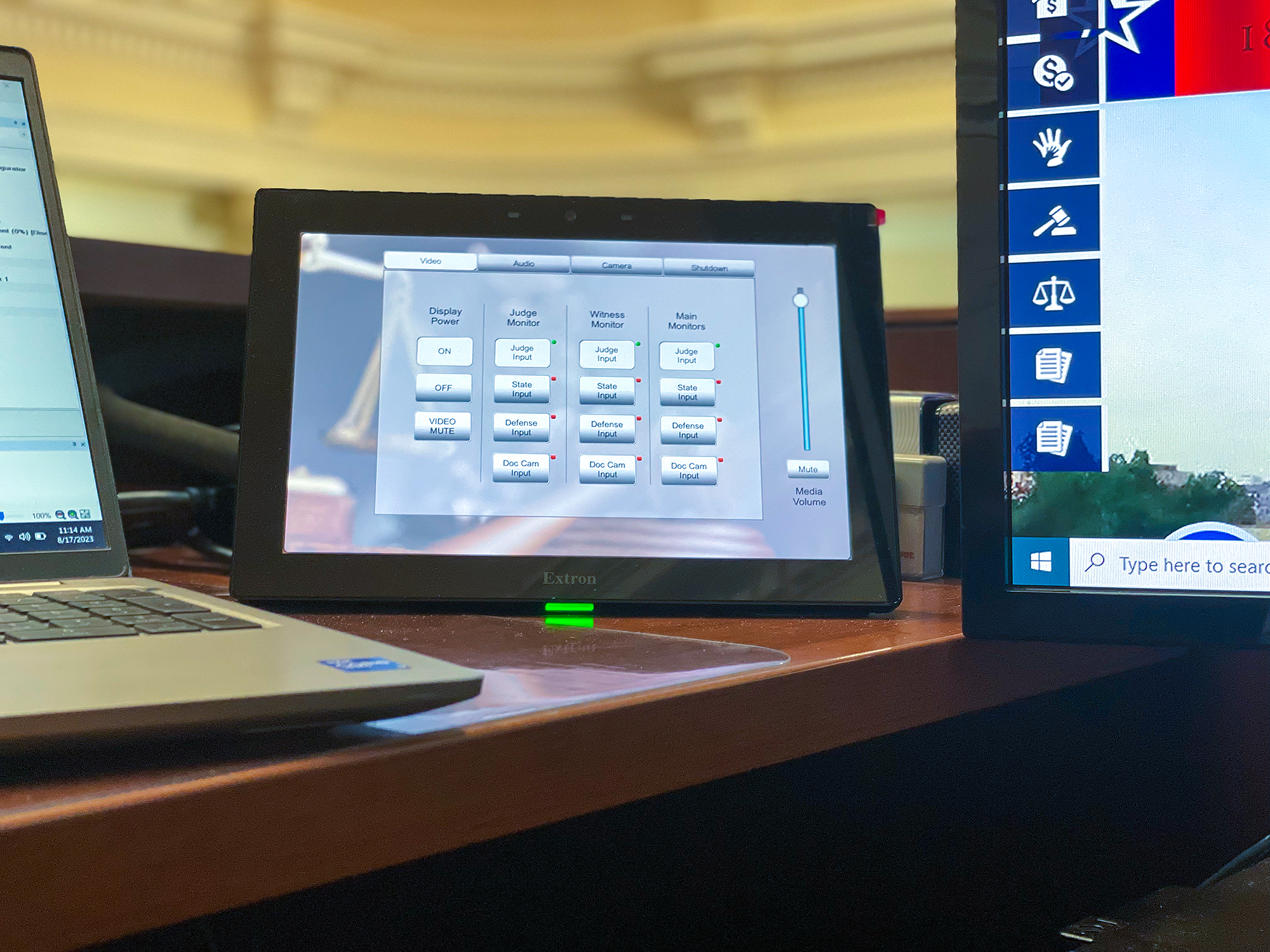 The AV sources include the judge’s PC, the prosecutor’s PC, the defense team’s PC, and a document camera at the lectern for hardcopy display. A PTZ camera tied into the AV system supports Zoom/Teams calls.