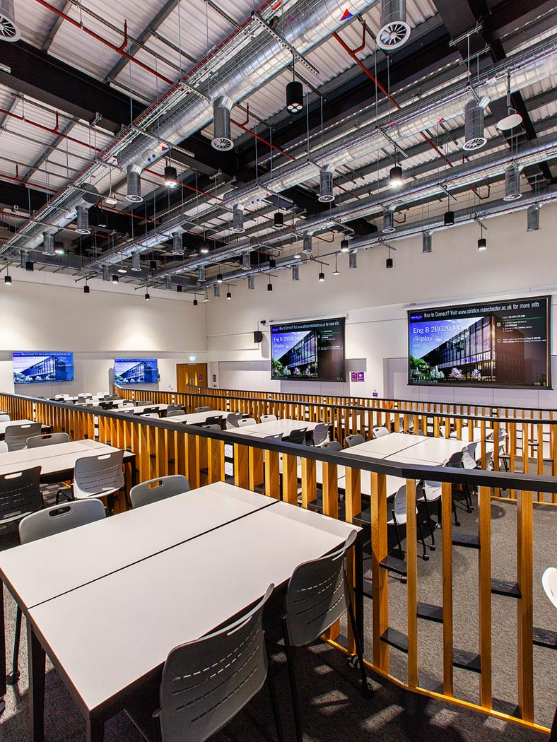 Thumbnail - On the lecture side of Blended Theater 2, each of the seven student workstations is associated with a 2x2 videowall to augment visibility and enhance collaboration.