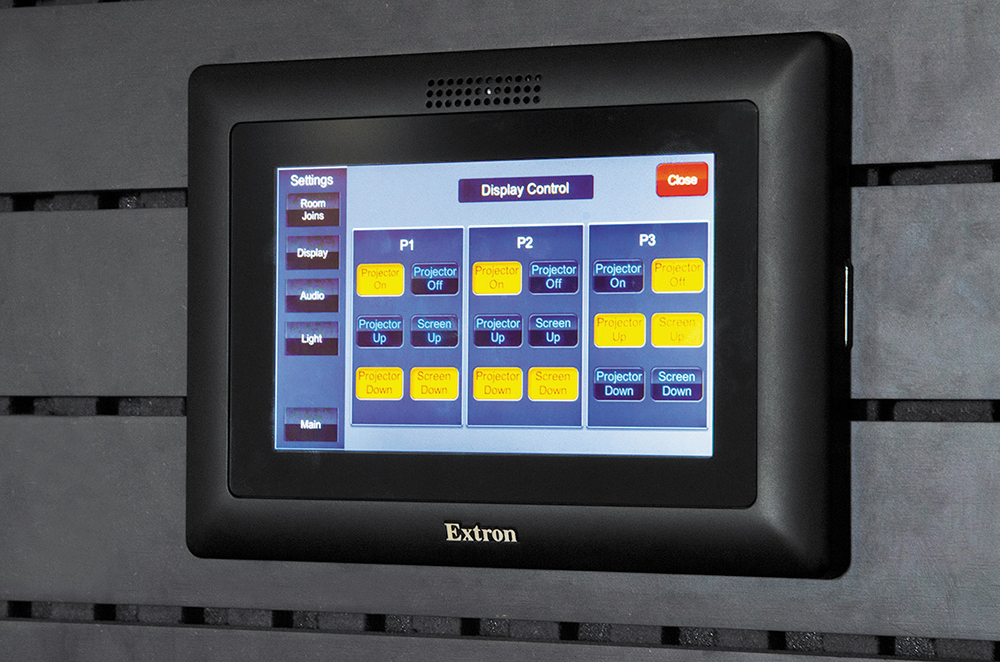 Both staff members and clients use an Extron TLP Pro 520M TouchLink Touchpanel to select among the room’s predetermined states, which include control of audio, projection systems, and lighting.