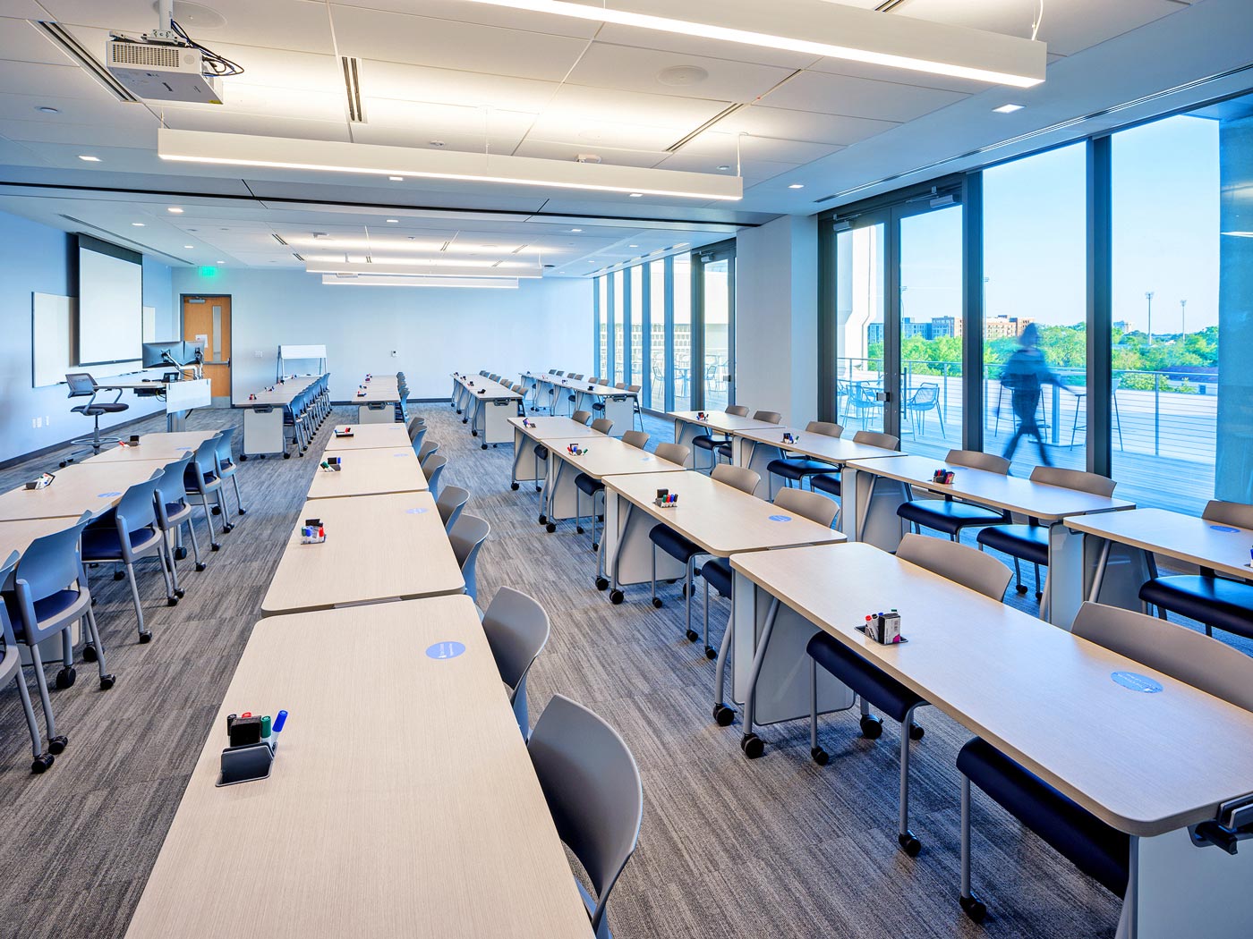 The divisible classroom, shown with the partition open, is equipped with the same AV system as standard classrooms, but with duplicate AV sources and duplicate speaker systems.