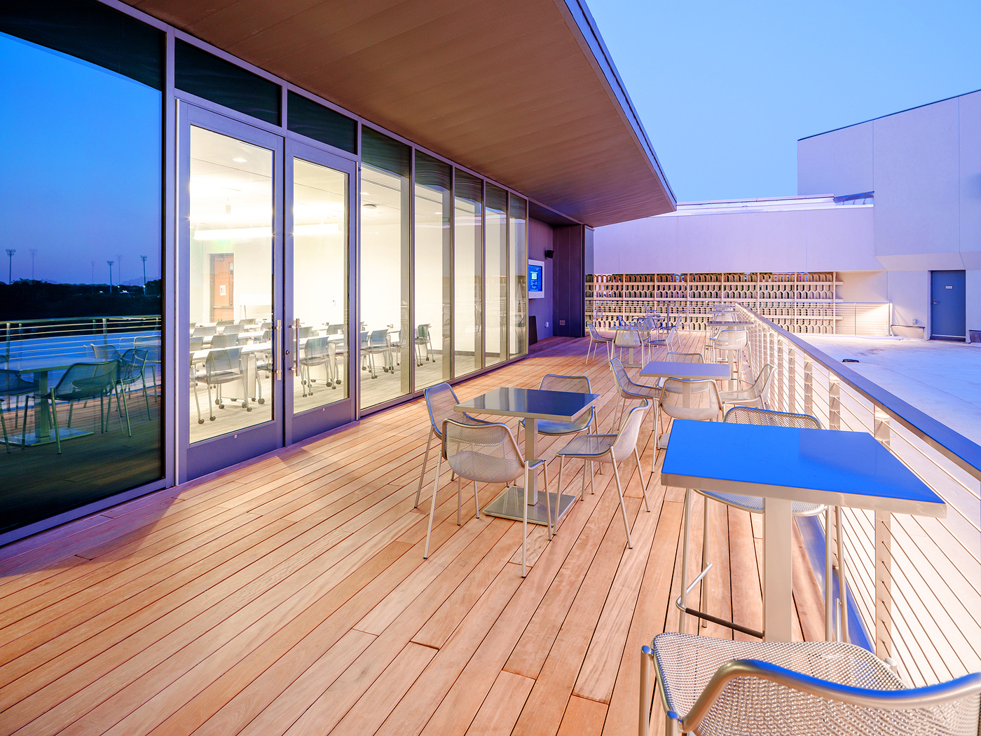 The rooftop terrace includes an AV alcove with 55" flat panel display and a sound system producing 200 watts of audio. From this angle, the flat panel display is visible at the far end of the terrace.