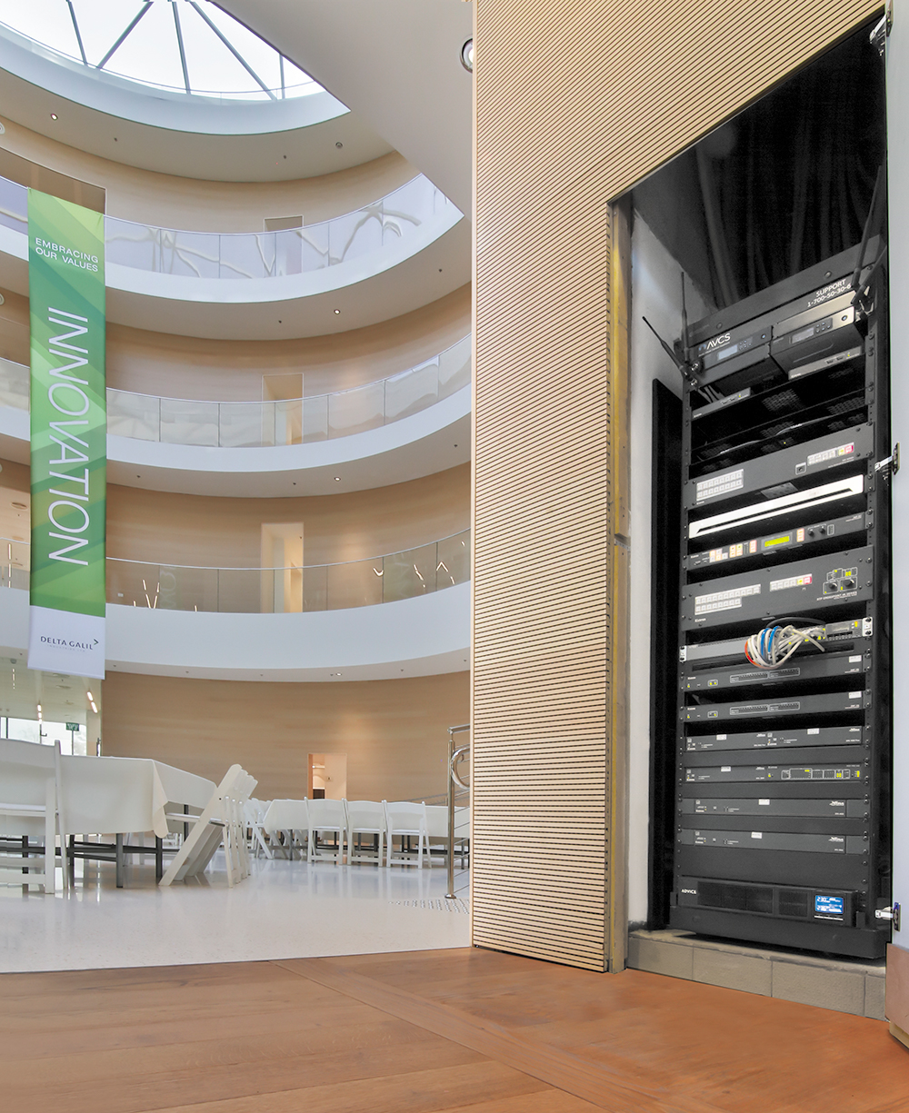 A DTP CrossPoint 108 4K IPCP MA 70 scaling presentation matrix switcher installed in a closet outside of the auditorium routes audio, video, and control signals for both the auditorium and the boardroom.