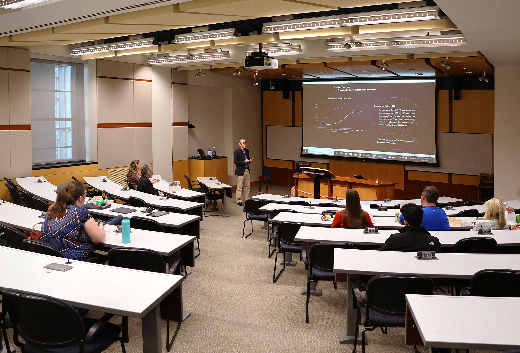 Room 3043 lecture hall with a projection screen, plus side flat panel display. Accommodates 89 students and five instructors.