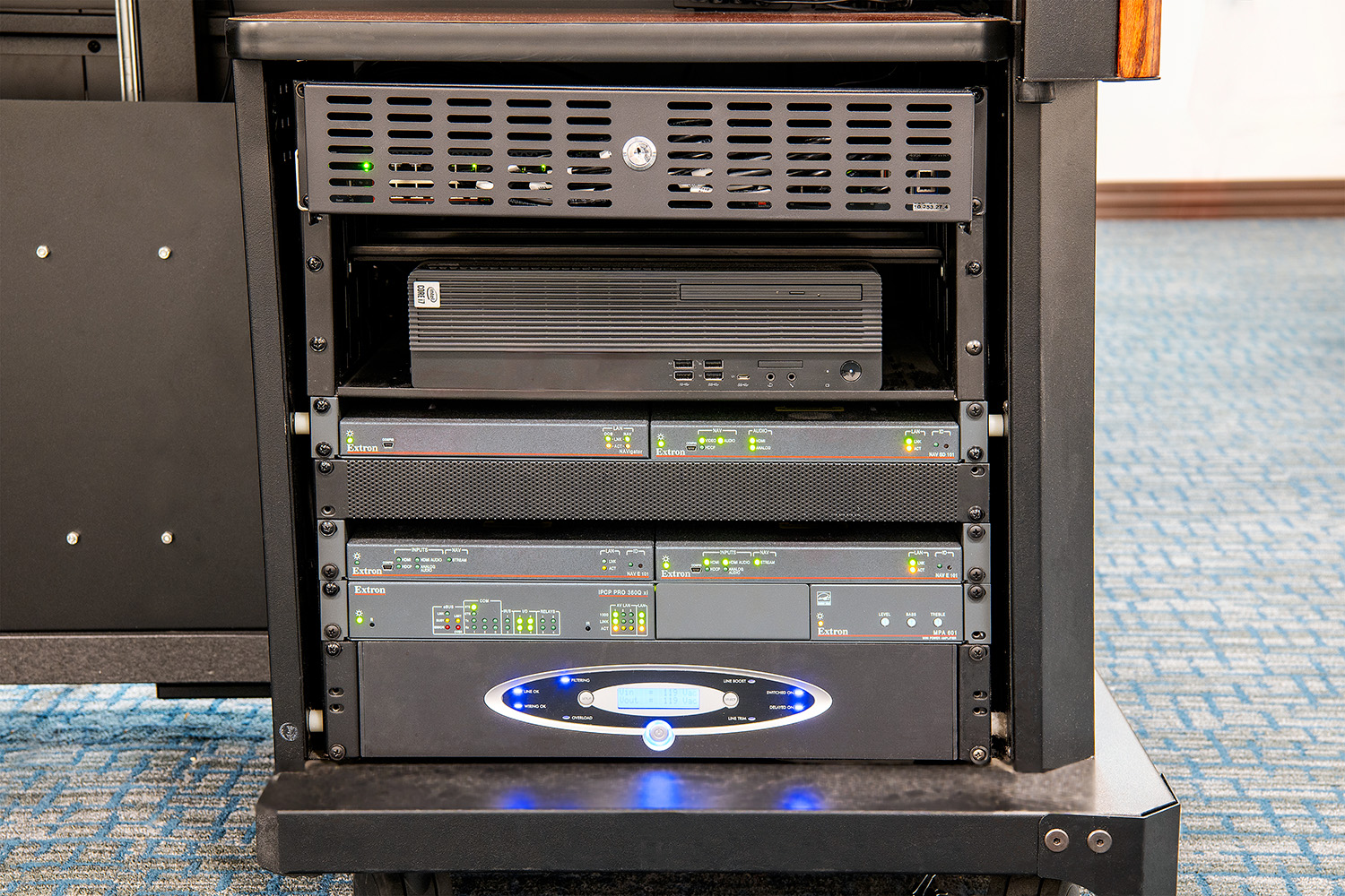 The NAV AVoIP products and other AV system components fit easily within the instructor station rack, occupying less space than the previous twisted pair AV switching system.