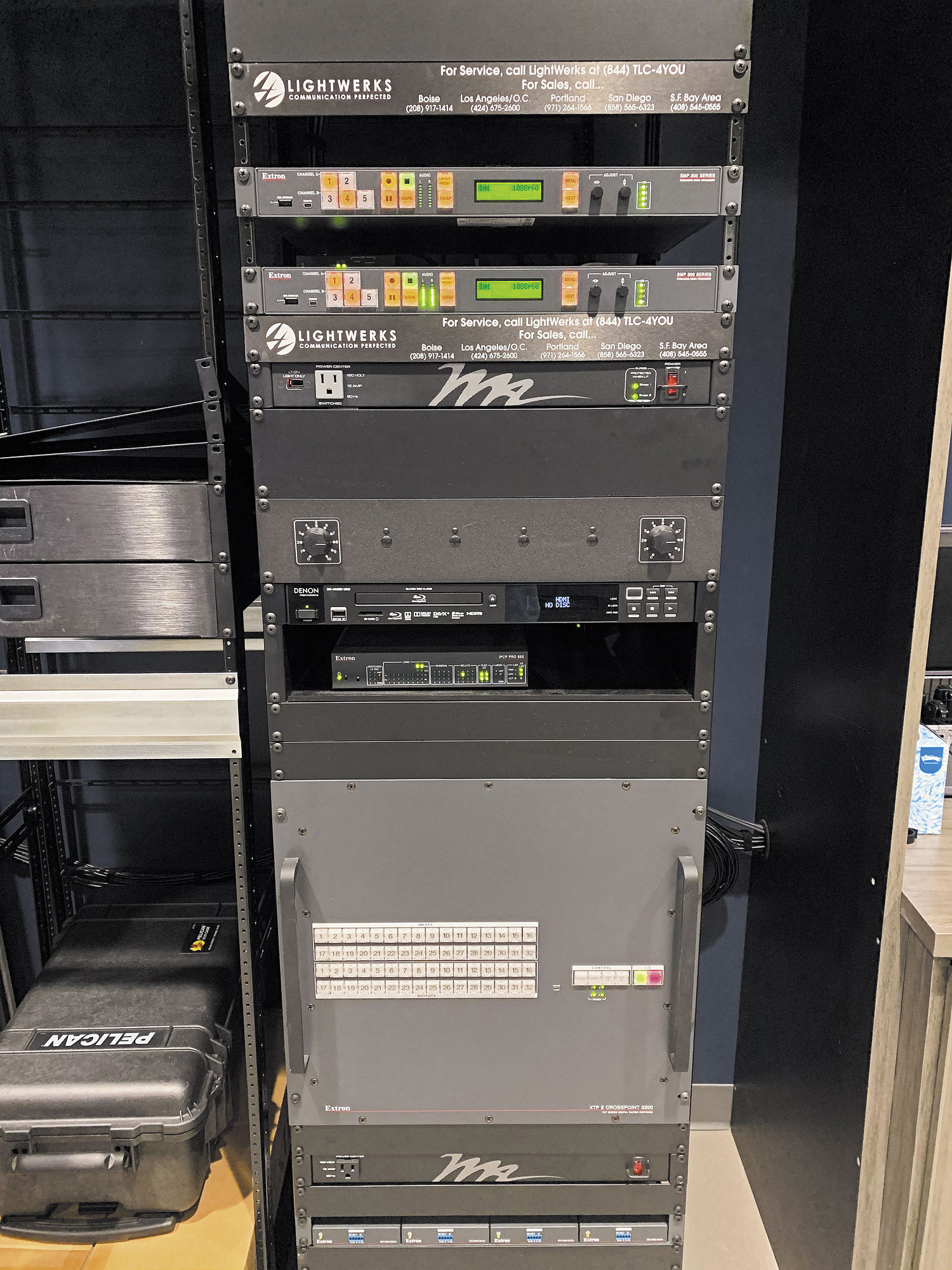 The XTP II CrossPoint 3200 matrix switcher and other AV components that supports the auditorium are rack-mounted in the control room.