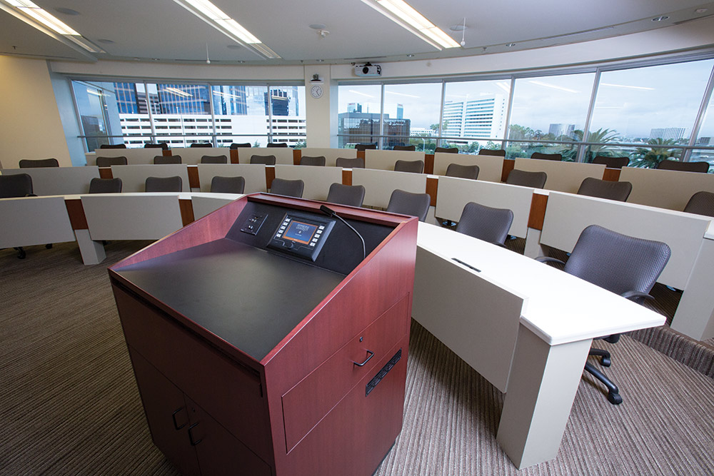 The lectern-mounted TouchLink touchpanel in the tiered classroom enables instructors to conveniently select sources and videoconferencing functions, adjust audio levels, and more.