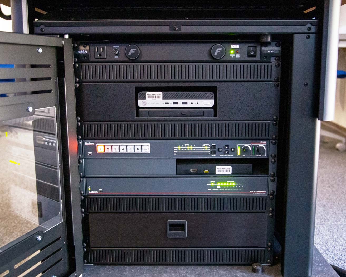 AV Podium base houses AV switching, distribution, and control equipment.