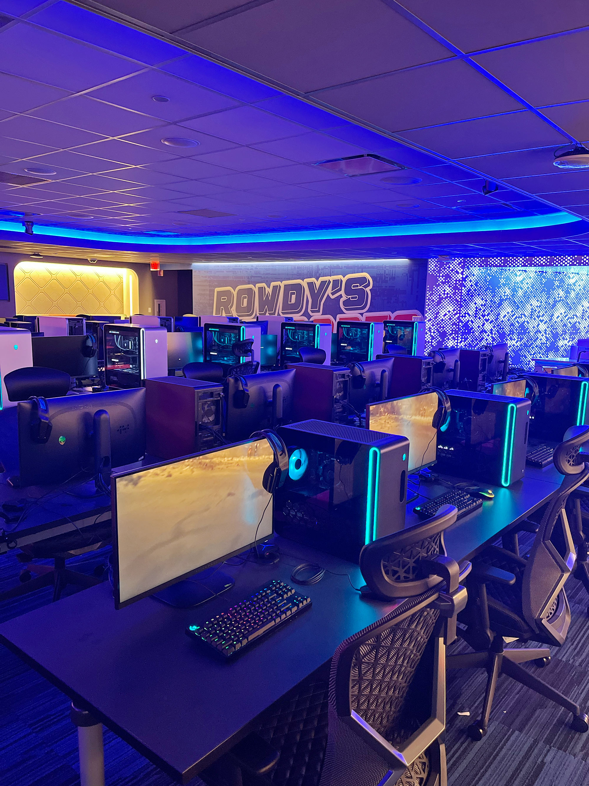 Rows of high-performance gaming stations create an immersive esports experience powered by Extron technology.