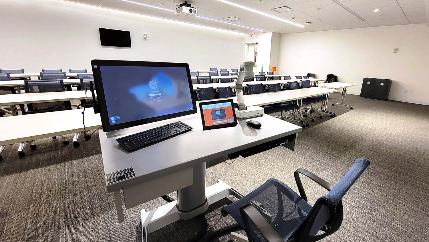 The standard classroom presentation workstation is a Steelcase AirTouch height-adjustable table outfitted with a micro-PC, an annotation touch screen, a Blu-ray player, a document camera, AV connectivity with power, and an Extron TLP Pro 1025T 10” Tabletop TouchLink Pro Touchpanel for system control.