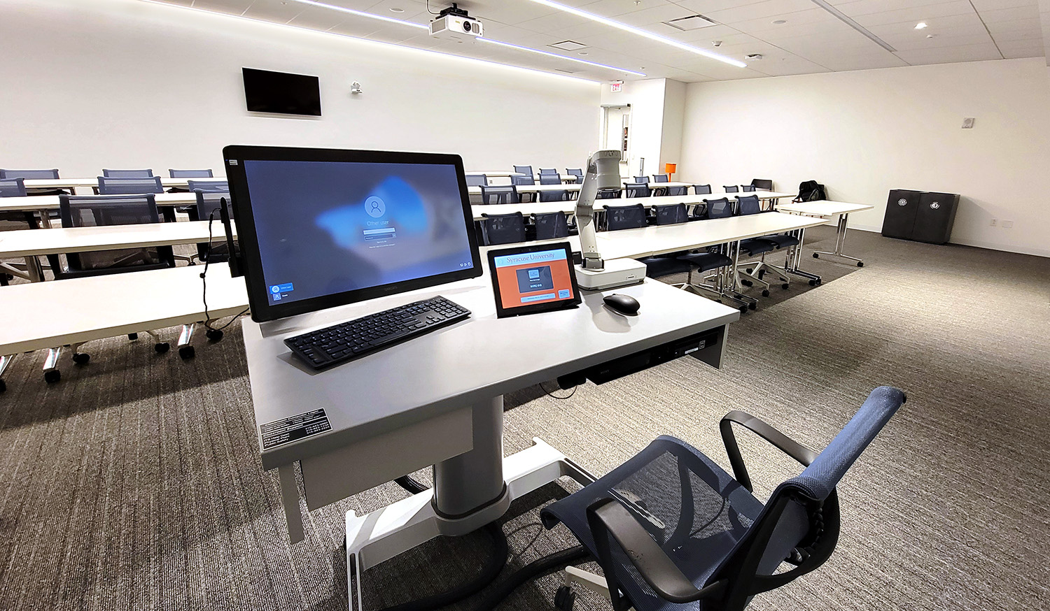 The standard classroom presentation workstation is a Steelcase AirTouch height-adjustable table outfitted with a micro-PC, an annotation touch screen, a Blu-ray player, a document camera, AV connectivity with power, and an Extron TLP Pro 1025T 10" Tabletop TouchLink Pro Touchpanel for system control.