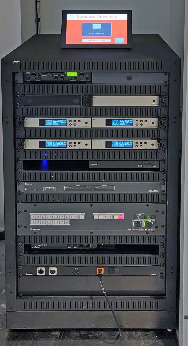 In the Grand Hall, the AV products are rack-mounted in an equipment room. An Extron TLP Pro 1025T 10” TouchLink Pro Touchpanel on the rack offers local system control.