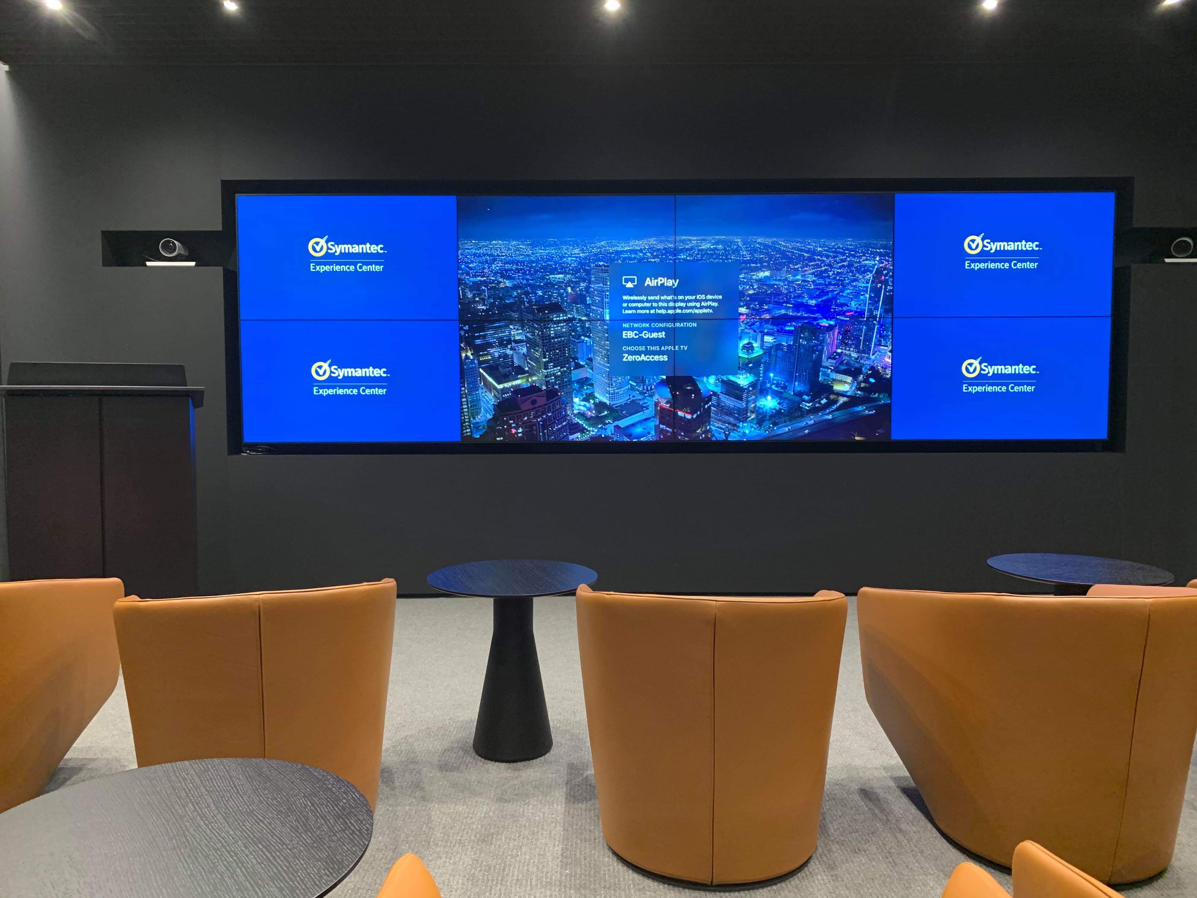 In spaces such as Demo Room 1, a 4x2 videowall driven by a Quantum Ultra 610 videowall processor displays selectable arrangements of source content in resolutions up to 4K/60 with 4:4:4 color sampling.