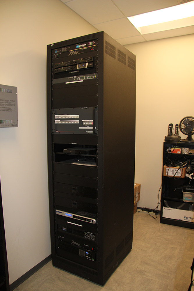 The XTP CrossPoint and shared resources are rack mounted within an equipment room adjacent to the pre-function area.