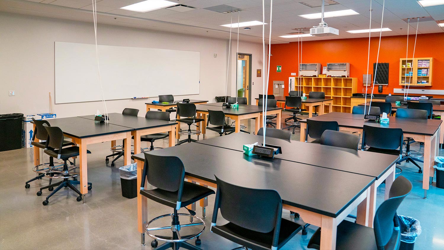 Sixteen rooms located on all five floors of the Apodaca Science Building, including Room 413 shown here, function as 18- to 24-seat lab and prelab spaces. They all share the same AV system design, consisting of a projector that receives wired and wireless content from a ShareLink Pro presentation gateway. Program audio from the projector is sent to two portable assisted listening systems and to Flat Field ceiling speakers via an MDA 3A Audio Distribution Amplifier. The ceiling speakers, four or six depending on room size, are driven by an MPA amplifier. Users operate the AV system through a MediaLink Plus Controller.