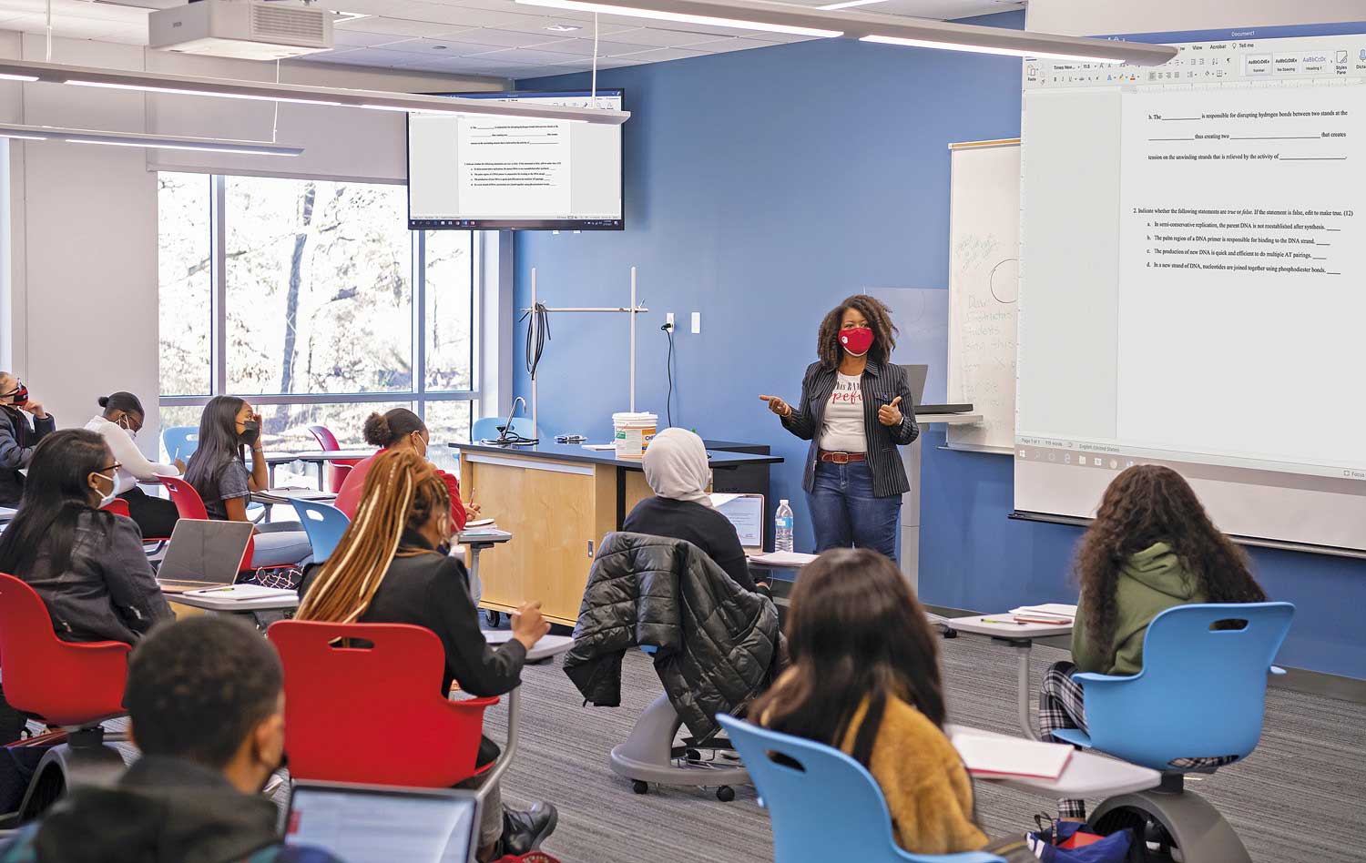 Popular Health Science and Cell Biology courses are taught in large classrooms with multiple AV displays. Cell Biology class session is shown here.
